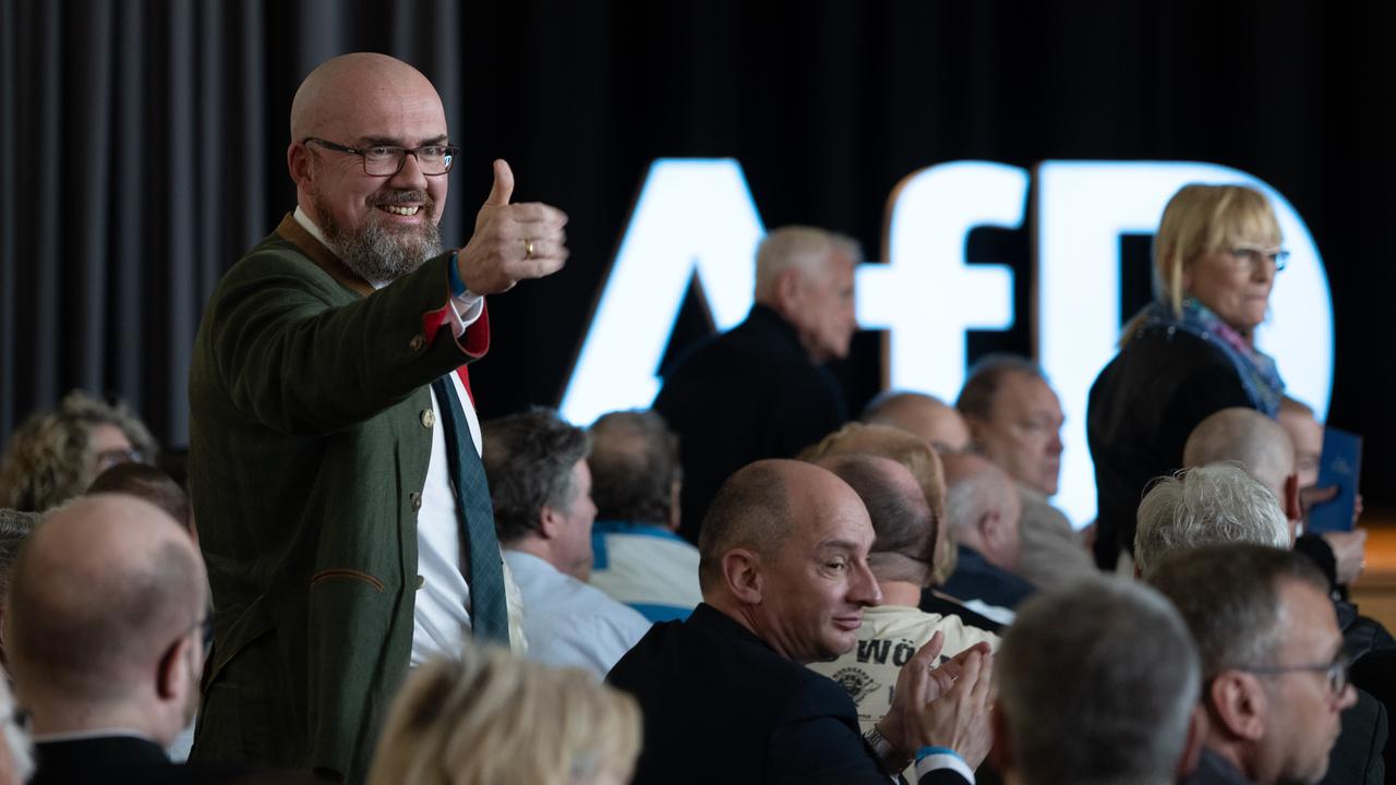 Hans-Thomas Tillschneider ist Landtagsabgeordneter der AfD Sachsen-Anhalt. Der bärtige Mann mit Glatze in tannengrünem Jacket macht das Daumen-hoch-Zeichen und grinst auf dem Landesparteitag in Weißandt-Gölzau am 22. April 2023.