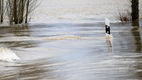 Ein Straßenpfosten bei Ebing (Landkreis Bamberg) steht im Hochwasser.
