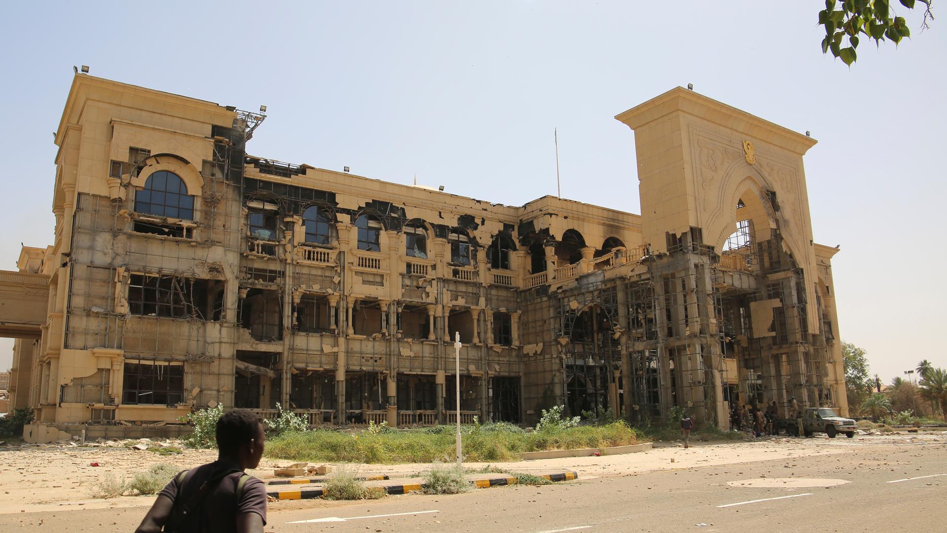 Ein Soldat geht vor dem Gebäude entlang. Der Himmel darüber ist hellblau. Ein Soldat geht vor dem Gebäude entlang. Der Himmel darüber ist hellblau.