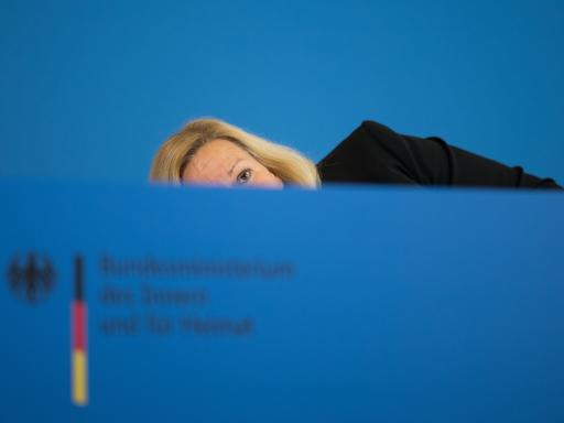 Nancy Faeser (SPD), Bundesministerin für Inneres und Heimat, bückt sich nach einer Pressekonferenz zur Bekämpfung der Organisierten Kriminalität und zur Änderung des Sprengstoffgesetzes, um ihre Krücken aufzuheben.