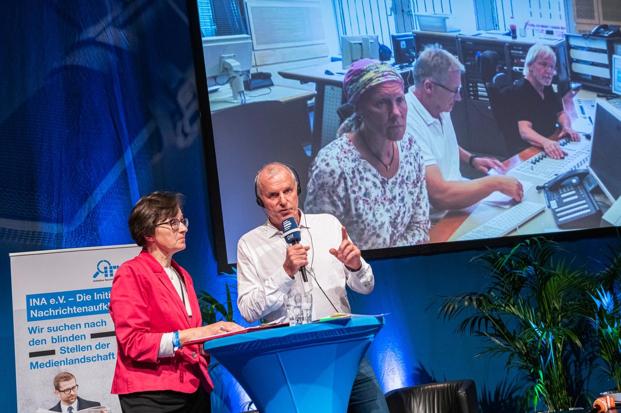 Zwei Menschen auf einer Bühne.