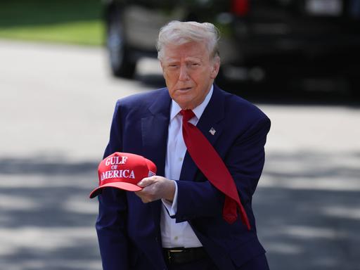 US-Präsident Donald Trump hält eine rote Basecap mit der Aufschrift "Gulf of America" in der Hand