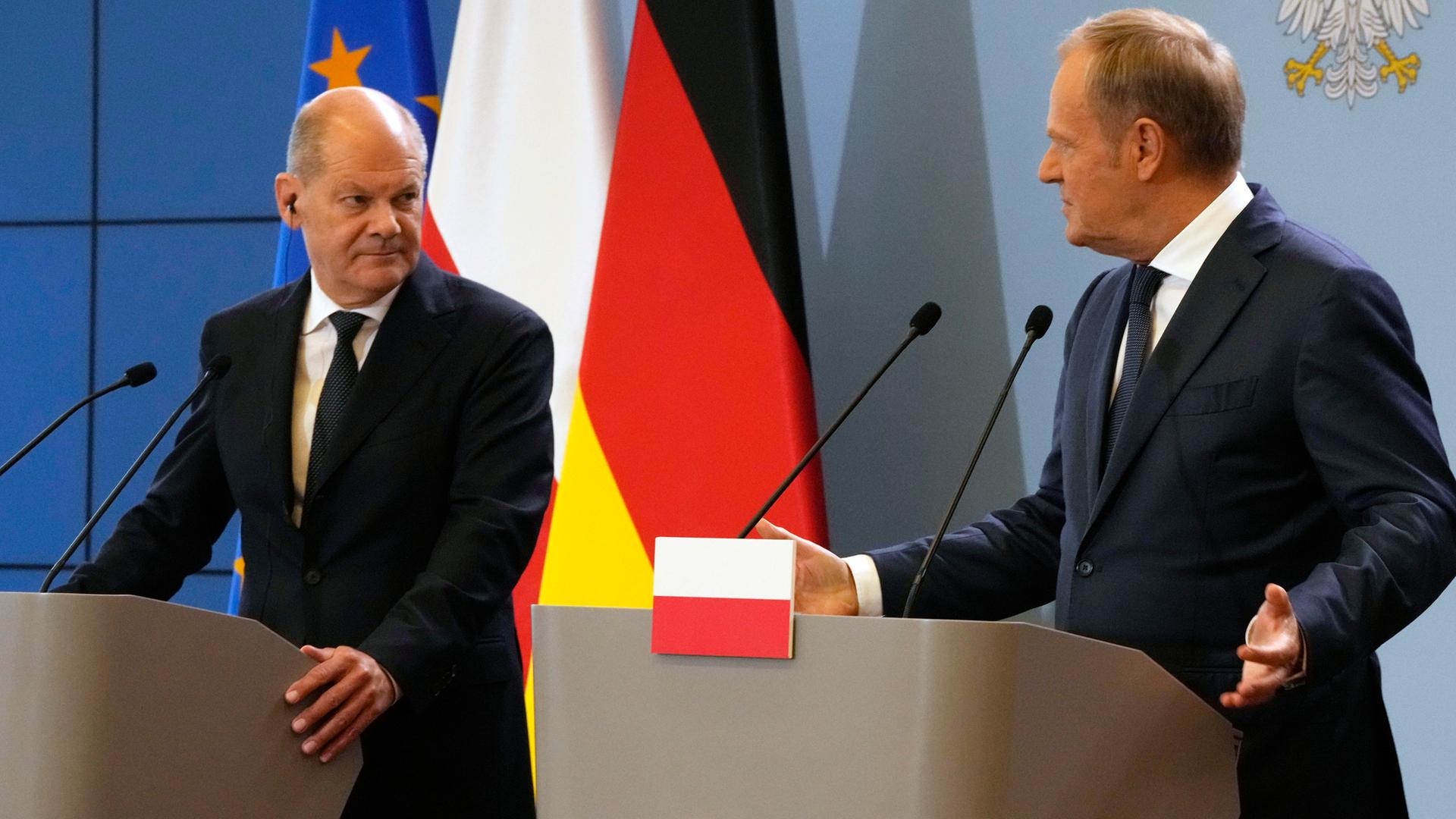 Bundeskanzler Scholz und der Ministerpräsident von Polen, Tusk, stehen bei einer Pressekonferenz an zwei Rednerpulten.