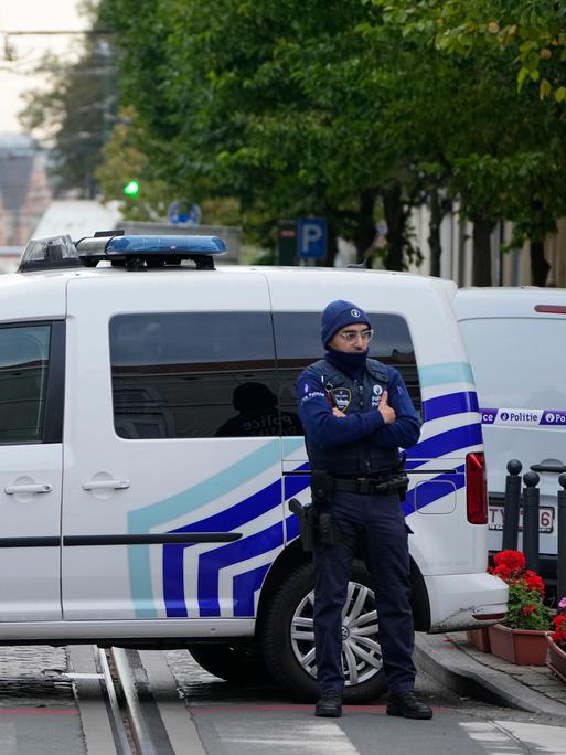 Belgian police stand behind a cordoned off area close to where a suspected Tunisian extremist was shot dead hours after a manhunt, in Brussels, Tuesday, Oct. 17, 2023, Police in Belgium on Tuesday shot dead a suspected Tunisian extremist accused of killing two Swedish soccer fans in a brazen shooting on a Brussels street before disappearing into the night on Monday. (AP Photo/Martin Meissner)
