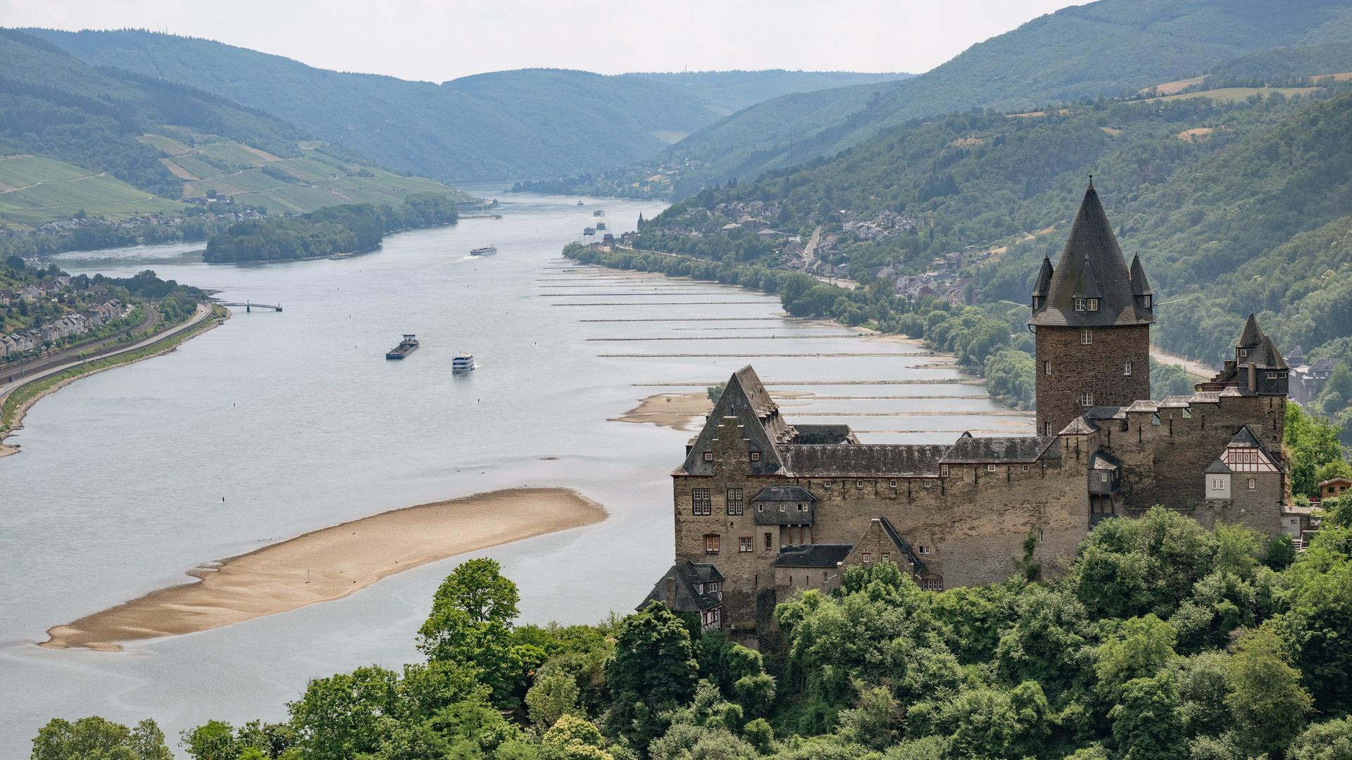 Rheinland-Pfalz, Bacharach: Schiffe fahren an der Burg Stahleck vorbei auf dem Rhein. Im Fluss ist eine große Sandbank zu erkennen. Rheinland-Pfalz, Bacharach: Schiffe fahren an der Burg Stahleck vorbei auf dem Rhein. Im Fluss ist eine große Sandbank zu erkennen.