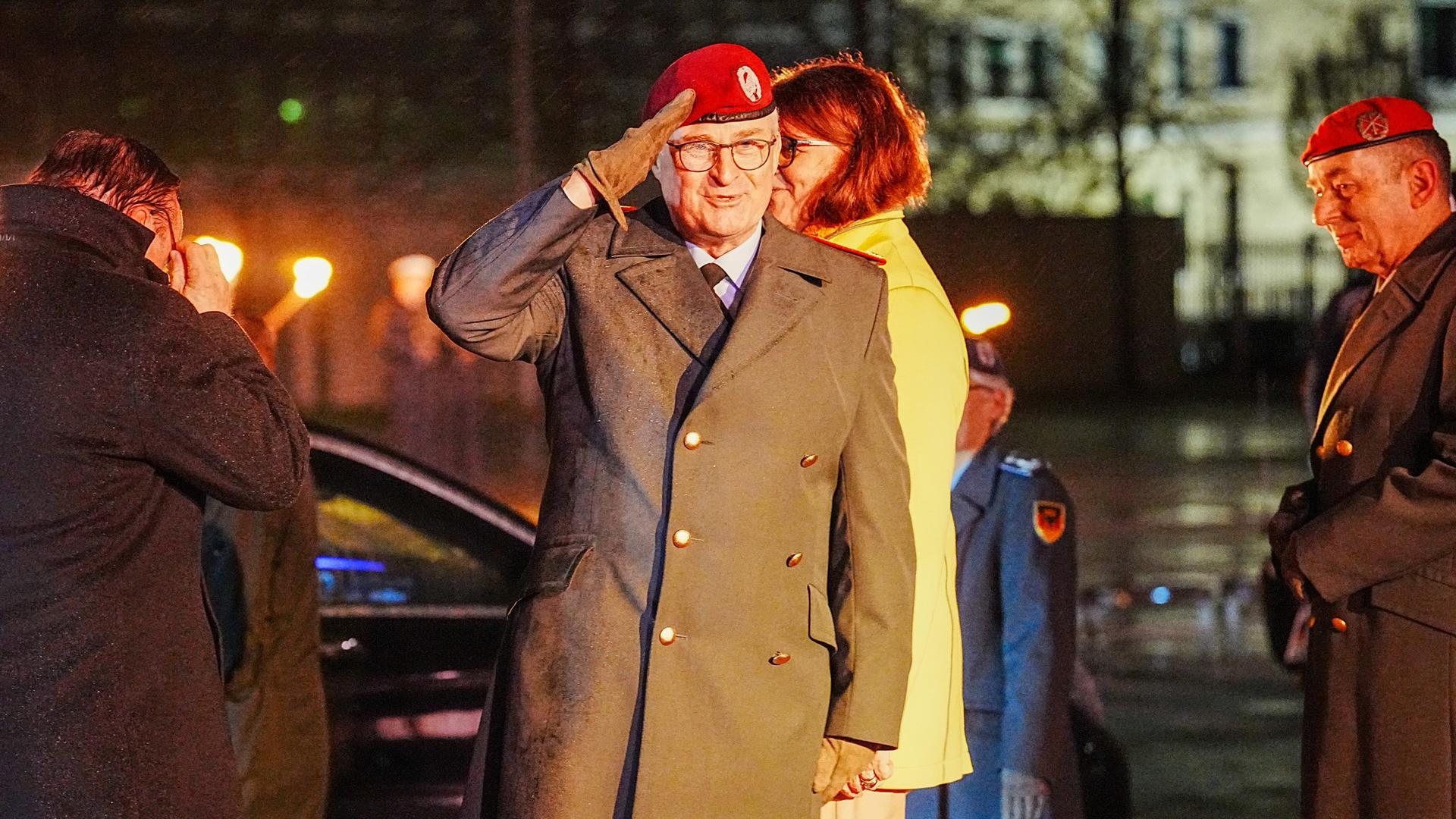 Eberhard Zorn (M), ehemaliger Generalinspekteur der Bundeswehr, salutiert. Er hält die rechte Hand an sein rotes Barett.