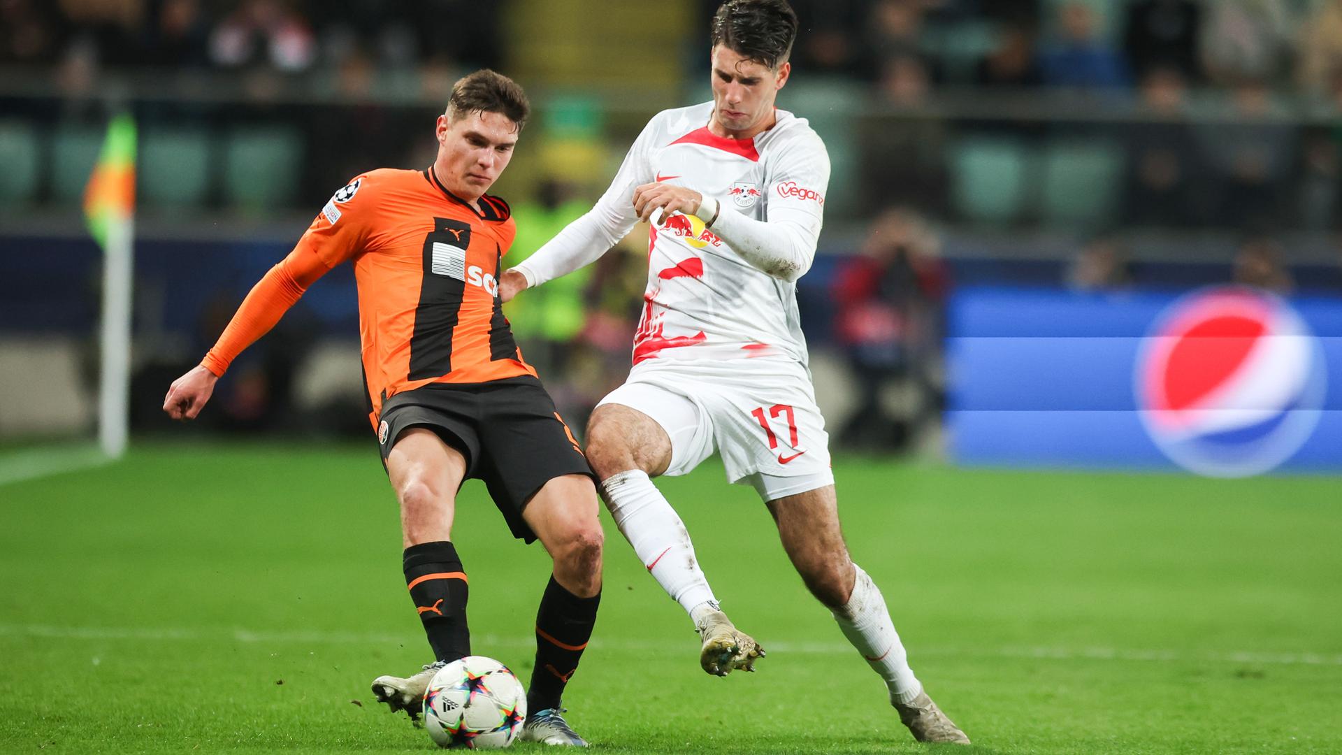 Das Bild zeigt einen Zweikampf im Fußball-Champions-League-Spiel zwischen Schachtjor Donezk und RB Leipzig zwischen Heorhij Sudakow von Donezk und Leipzigs Dominik Szoboszlai