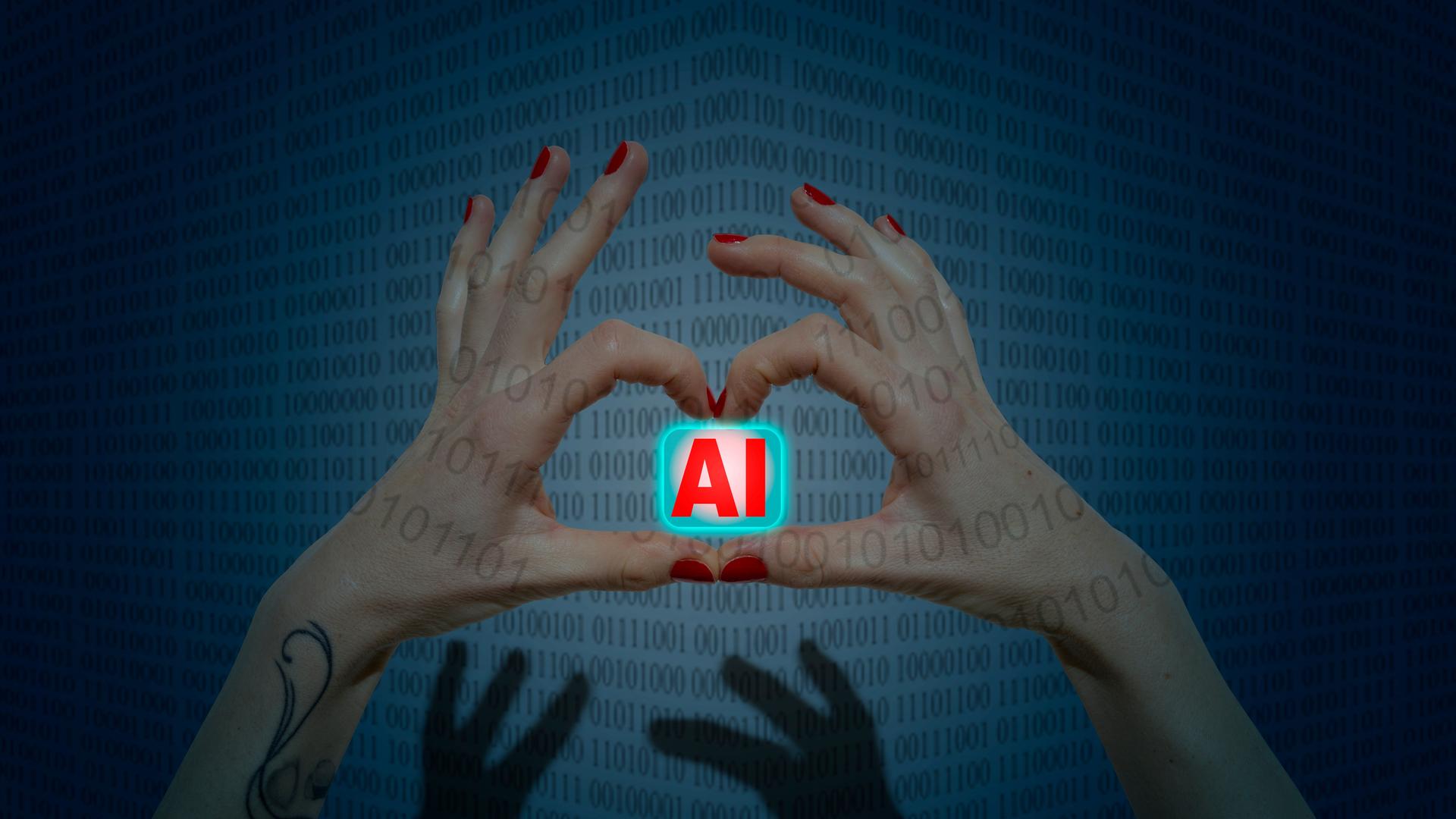 Zwei Hände mit rot lackierten Finger bilden eine Herzform in der sie ein Symbol mit dem Schriftzug AI (Artificial Intelligence) halten. Zwei Hände mit rot lackierten Finger bilden eine Herzform in der sie ein Symbol mit dem Schriftzug AI (Artificial Intelligence) halten.