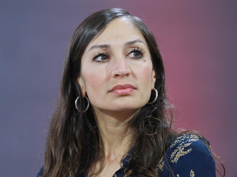 Eine Frau mit langen dunklen Haaren. Es ist die Autorin Gilda Sahebi.