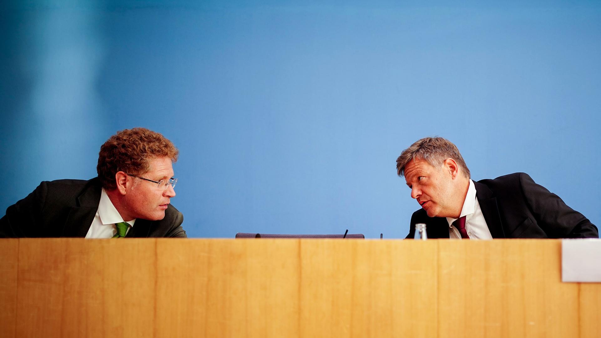 Robert Habeck (Bündnis 90/Die Grünen, r), Bundesminister für Wirtschaft und Klimaschutz (BMWK), und Patrick Graichen, Staatssekretär im BMWK sprechen miteinander. Hack beugt sich zu Graichen.