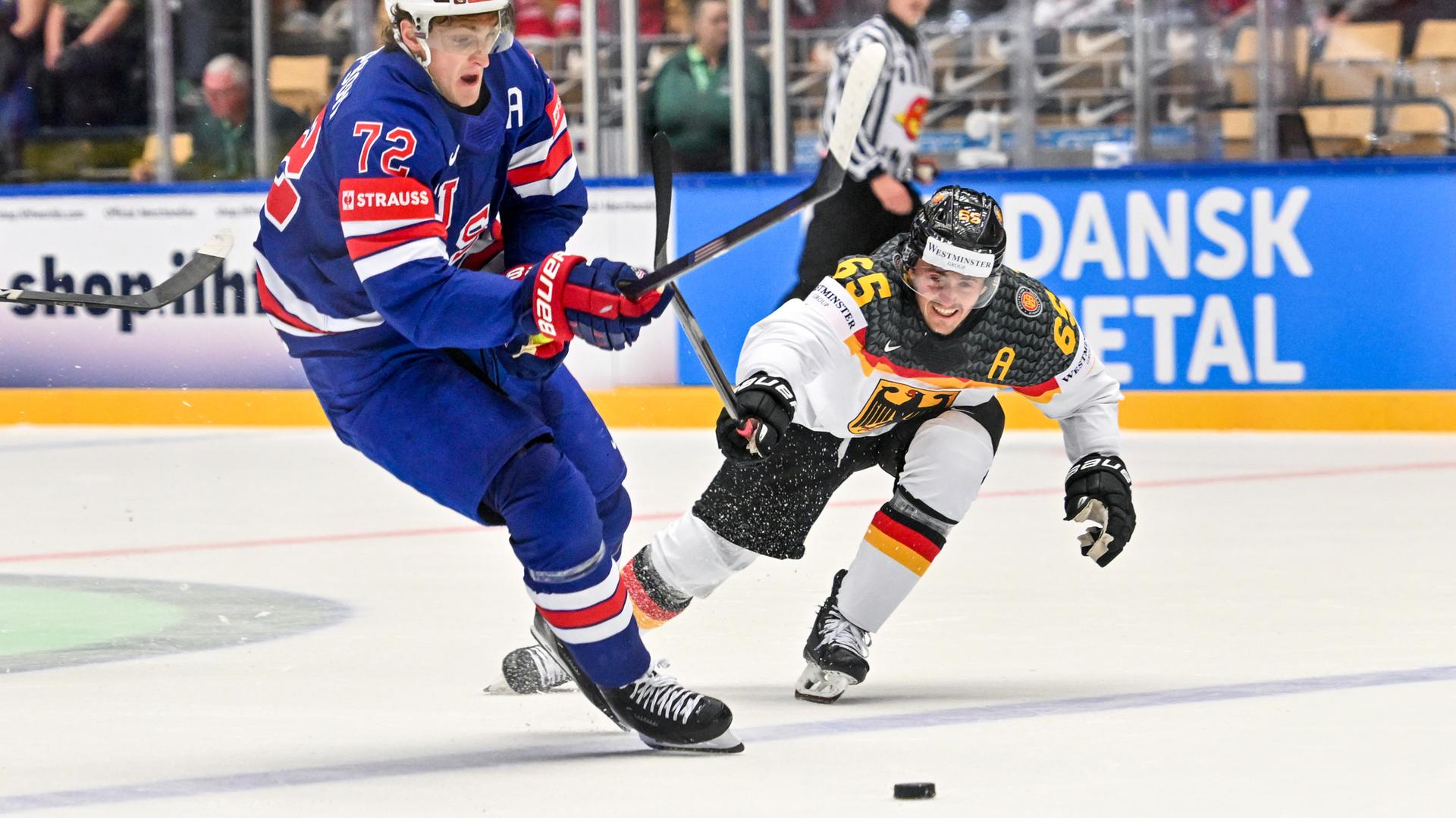 Zwei Eishockey-Spieler kämpfen um den Puck. 
