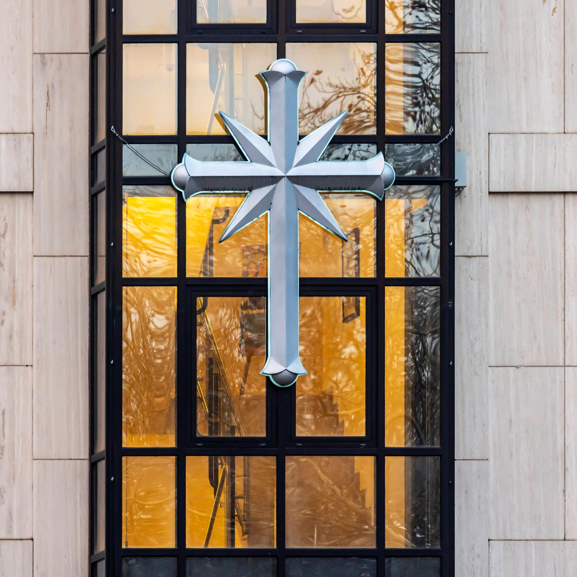Das Logo von Scientology, ein Kreuz angebracht an der Fassade vom Sitz der Sekte in Stuttgart.