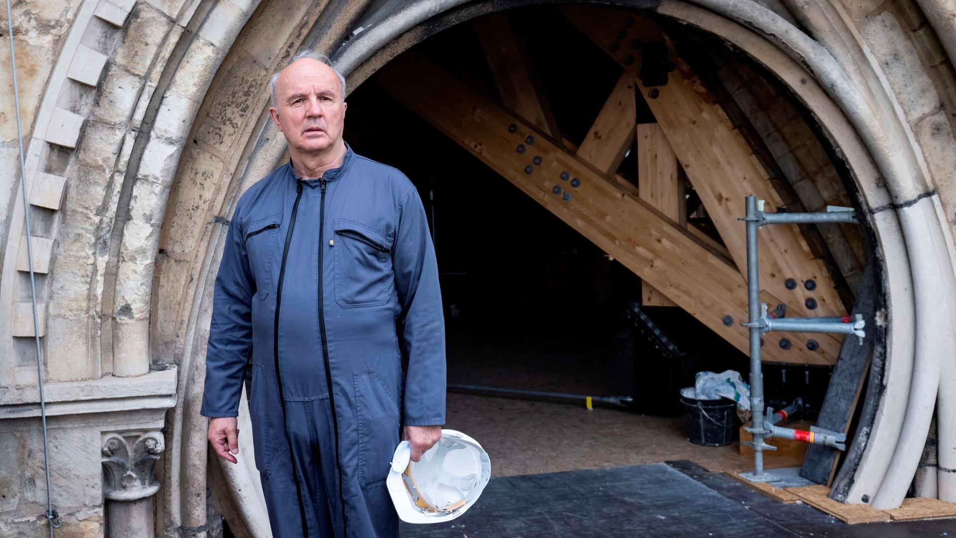Der Verantwortliche für den Wiederaufbau von Notre-Dame, Jean-Louis Georgelin, steht auf dem Dach der ausgebrannten Kathedrale. Er trägt einen blauen Overall und hat einen weißen Bauarbeiterhelm in der Hand. Der Verantwortliche für den Wiederaufbau von Notre-Dame, Jean-Louis Georgelin, steht auf dem Dach der ausgebrannten Kathedrale. Er trägt einen blauen Overall und hat einen weißen Bauarbeiterhelm in der Hand.
