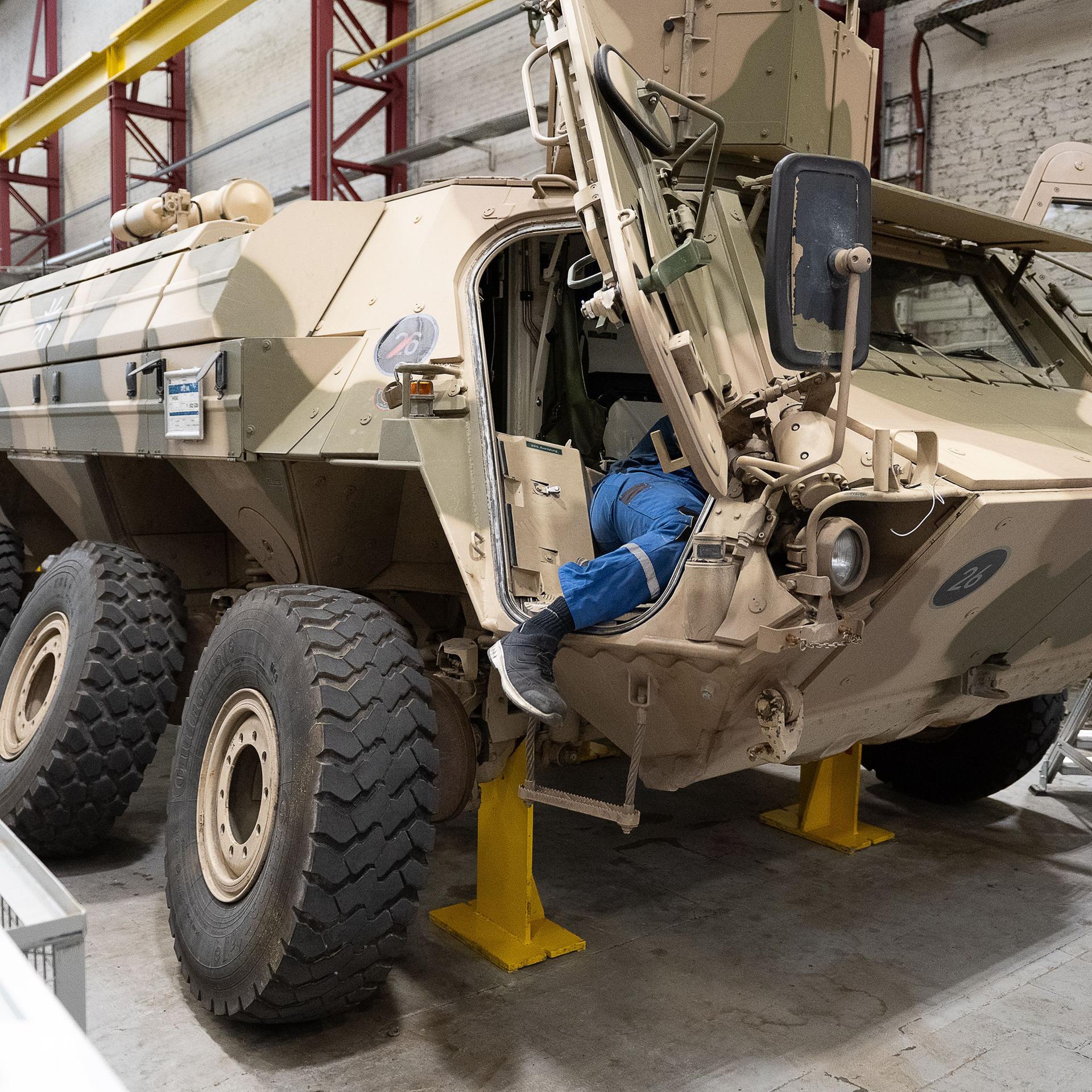 Hessen, Kassel: Ein Mitarbeiter von Rheinmetall arbeitet an einem Panzer vom Typ Fuchs in der Fertigungshalle von Rheinmetall. 