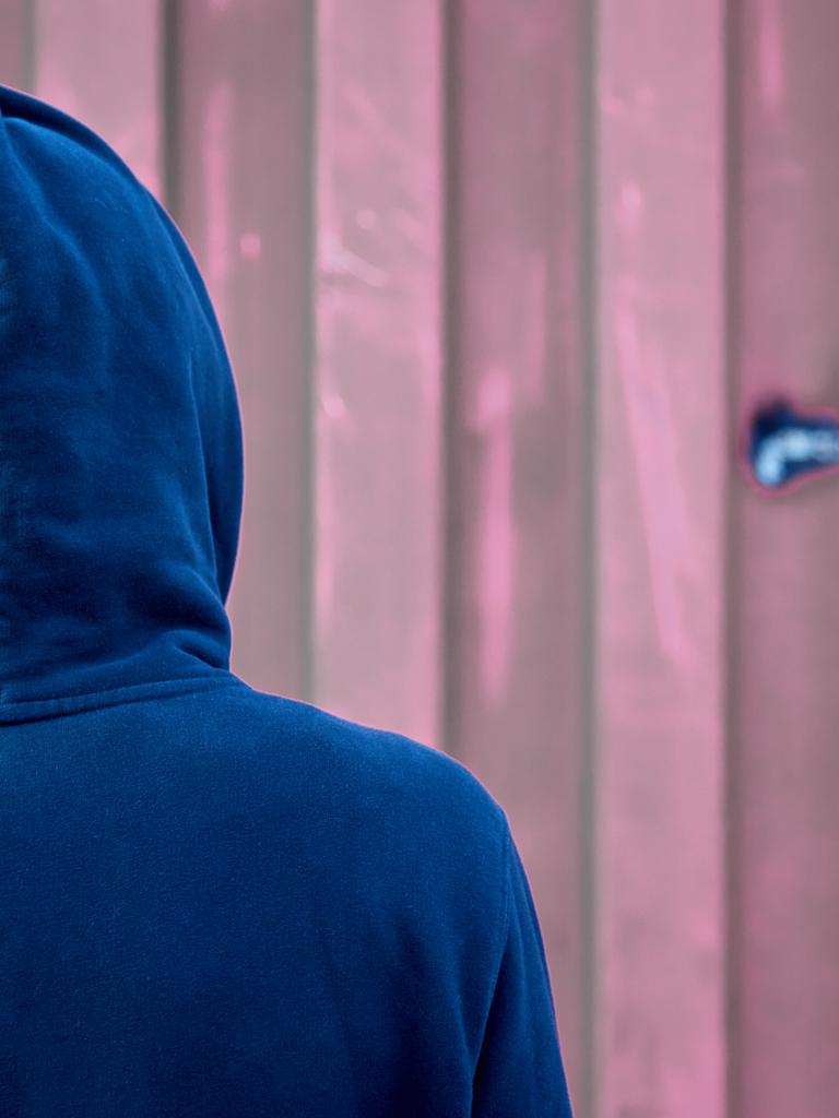 Aufnahme eines Jungen mit Kapuzenpulli von hinten. (Symbolbild)