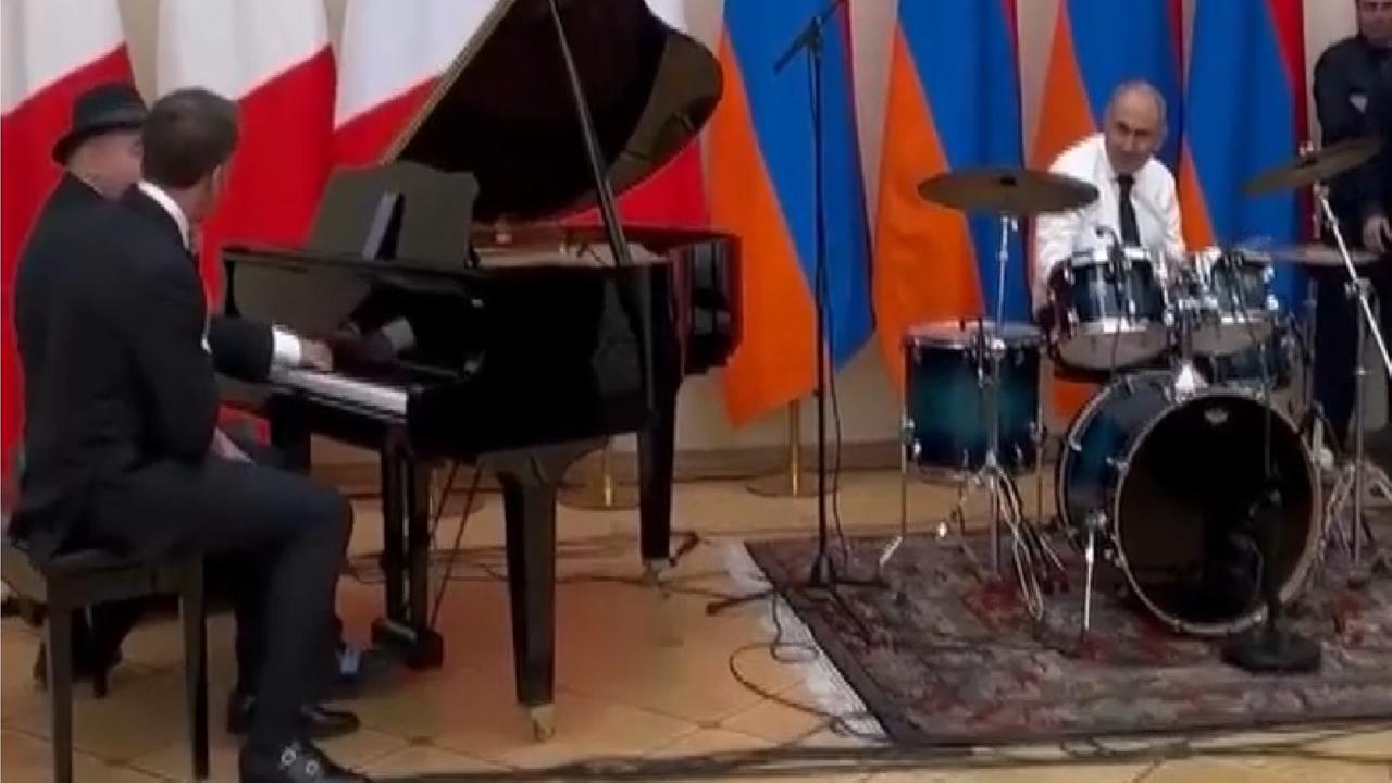 Frankreichs Präsident Emanuel Macron und ein zweiter Mann am Klavier, Armeniens Ministerpräsident Nikol Paschinjan ist am Schlagzeug.