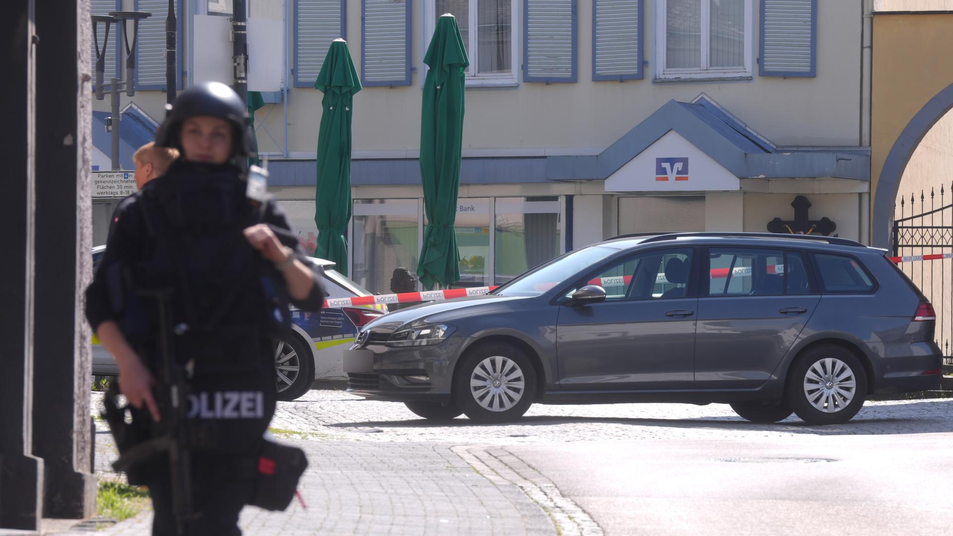 Polizisten stehen an einem Einsatzort. In einer Bankfiliale im rheinland-pfälzischen Sinzig ist es zu einer Geiselnahme gekommen. 