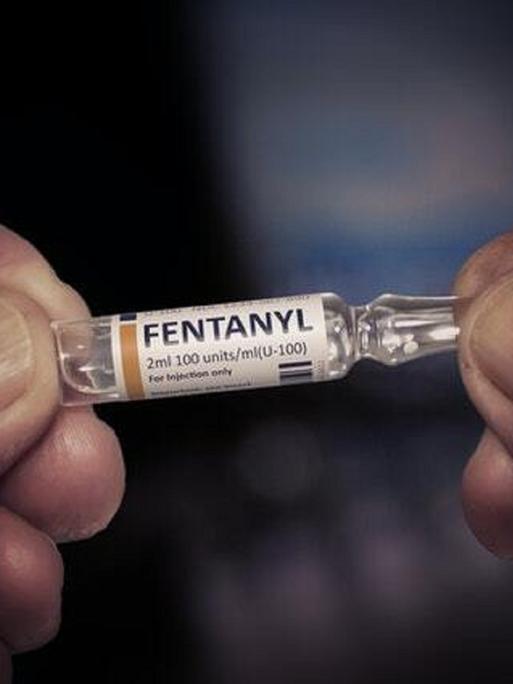 Ein Mann hält eine kleine Ampulle mit Fentanyl gefüllt in den Händen.