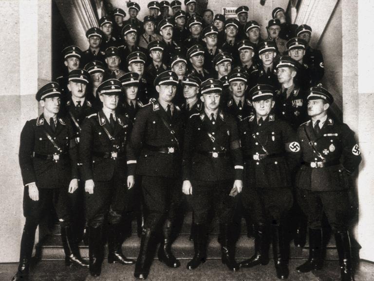 Das Schwarz-Weiß-Foto zeigt Mitglieder der SS mit Heinrich Himmler (mit Brille) auf einer Treppe