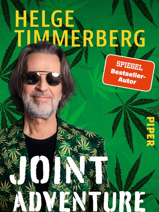 Das Buchcover von "Joint Adventure" zeigt den Autoren in einem Anzug mit Cannabis-Print und Sonnenbrille.