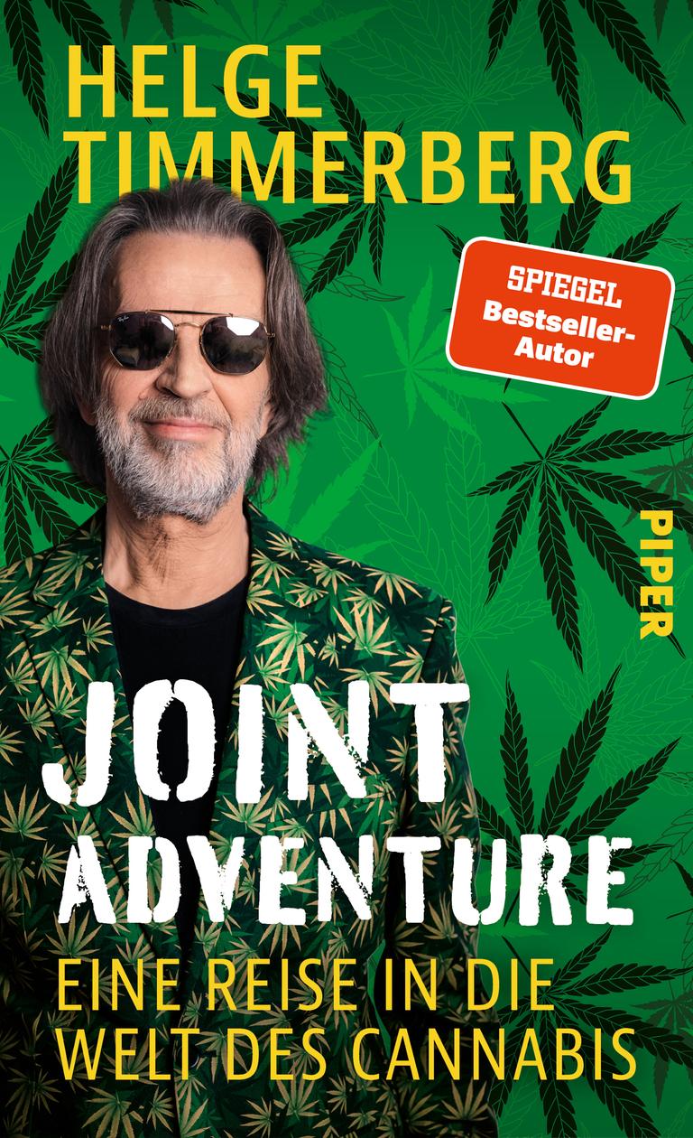 Das Buchcover von "Joint Adventure" zeigt den Autoren in einem Anzug mit Cannabis-Print und Sonnenbrille.
