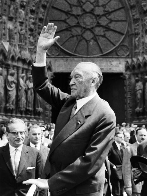 Bundeskanzler Konrad Adenauer winkt am 08.07.1962 vor der Kathedrale in Reims der französischen Bevölkerung zu. 