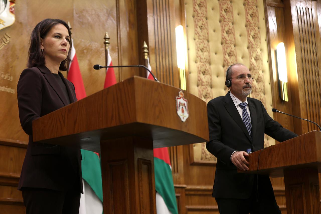 Baerbock steht bei einer Pressekonferenz in Amman am Rednerpult. Neben ihr der jordanische Außenminister Al-Safadi. Beide blicken ernst.