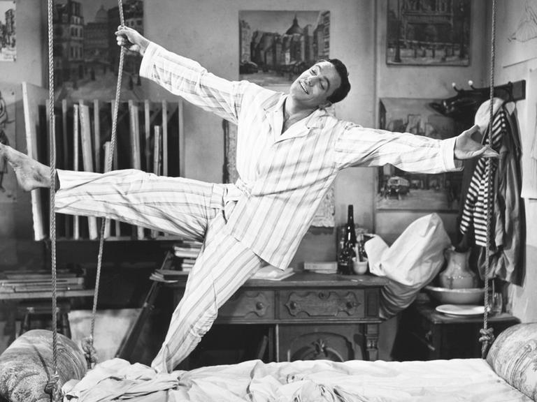 Gene Kelly singt "I've got a crush on you" (Ich bin in Dich verknallt) im Film "An American in Paris", 1951. Er singt und tanzt im Schlafanzug in seinem Bett.