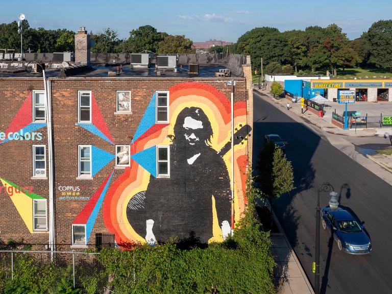 Blick auf einen Wohnblock, auf dem ein großes Bild den Sänger Sixto Rodriguez ehrt.