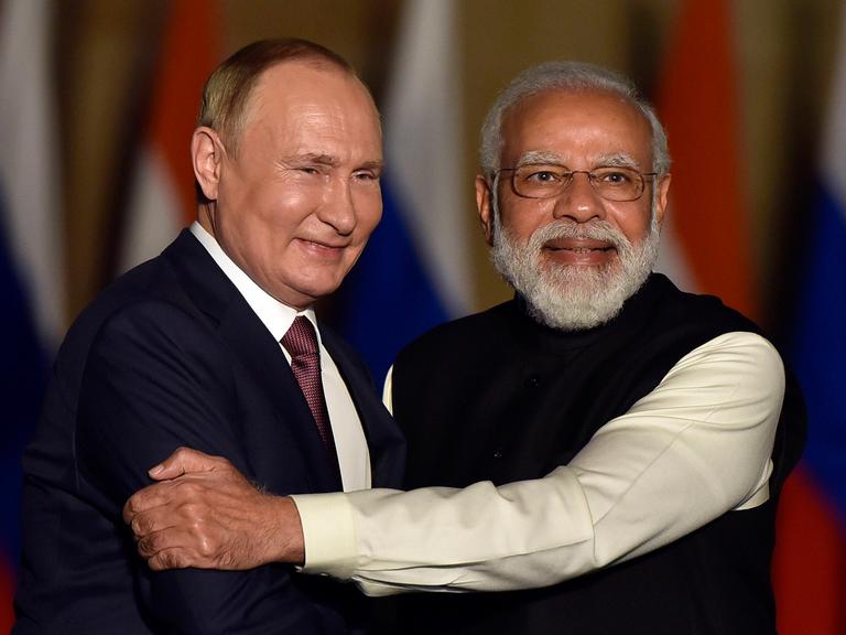 Der indische Premierminister Narendra Modi mit Vladimir Putin im Dezember 2021 in Neu Delhi. Modi umarmt Putin und hält seinen Arm fest.