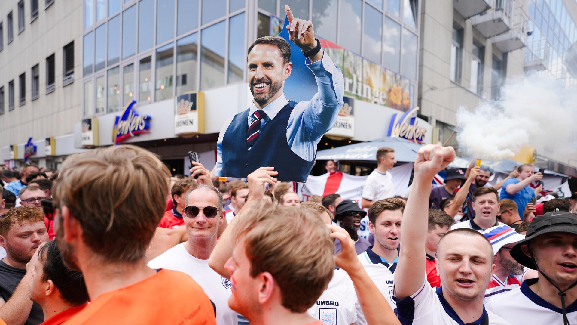 An England fan shows a placard of national coach Gareth Southgate during celebration ahead of a semi final match between Netherlands and England at the Euro 2024 soccer tournament in Dortmund, Germany, Wednesday, July 10, 2024. (AP Photo/Markus Schreiber)