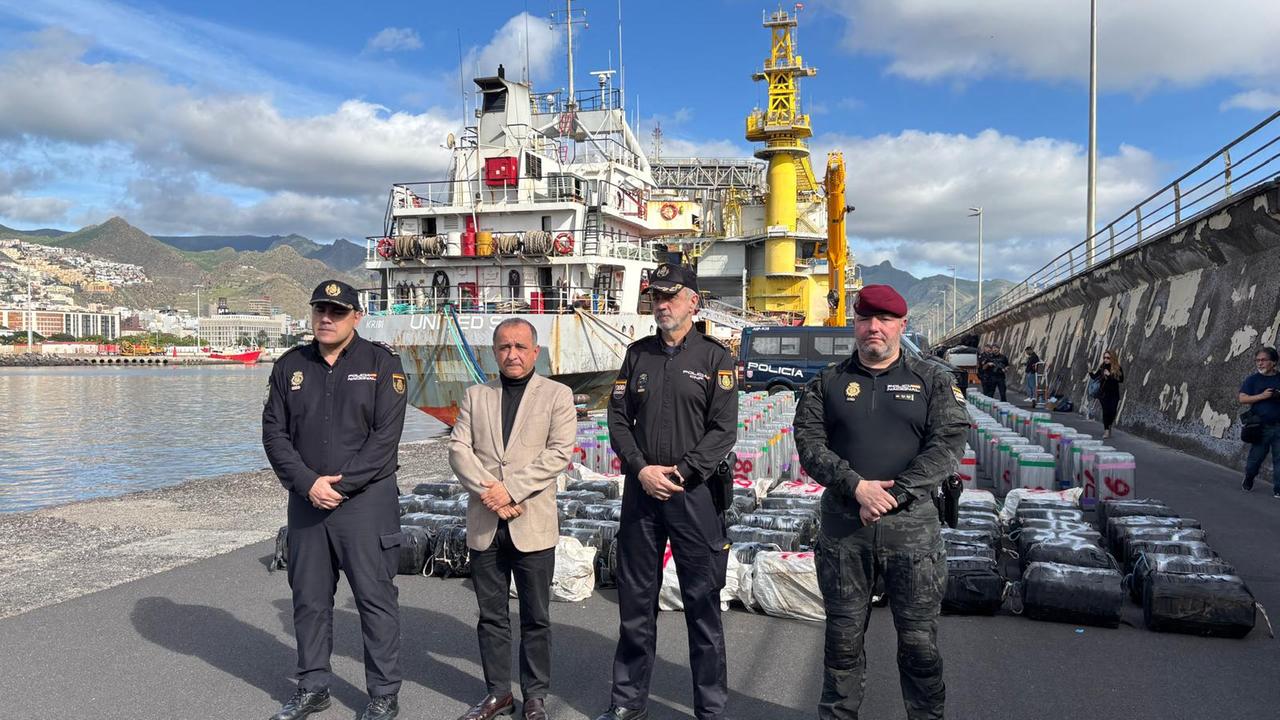 Vier spanische Beamte stehen vor dem Frachter, auf dem das Kokain gefunden wurde.