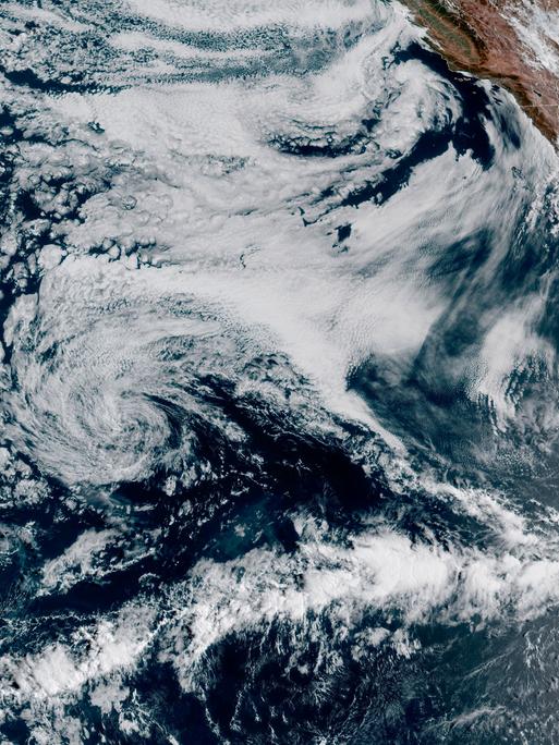 This Friday, Aug. 18, 2023, 1:10 p.m. EDT satellite image provided by the National Oceanic and Atmospheric Administration shows Hurricane Hilary, right, off Mexico's Pacific coast. Scientists figure a natural El Nino, human-caused climate change, a stubborn heat dome over the nationâs midsection and other factors cooked up Hilaryâs record-breaking slosh into California and Nevada. (NOAA via AP)