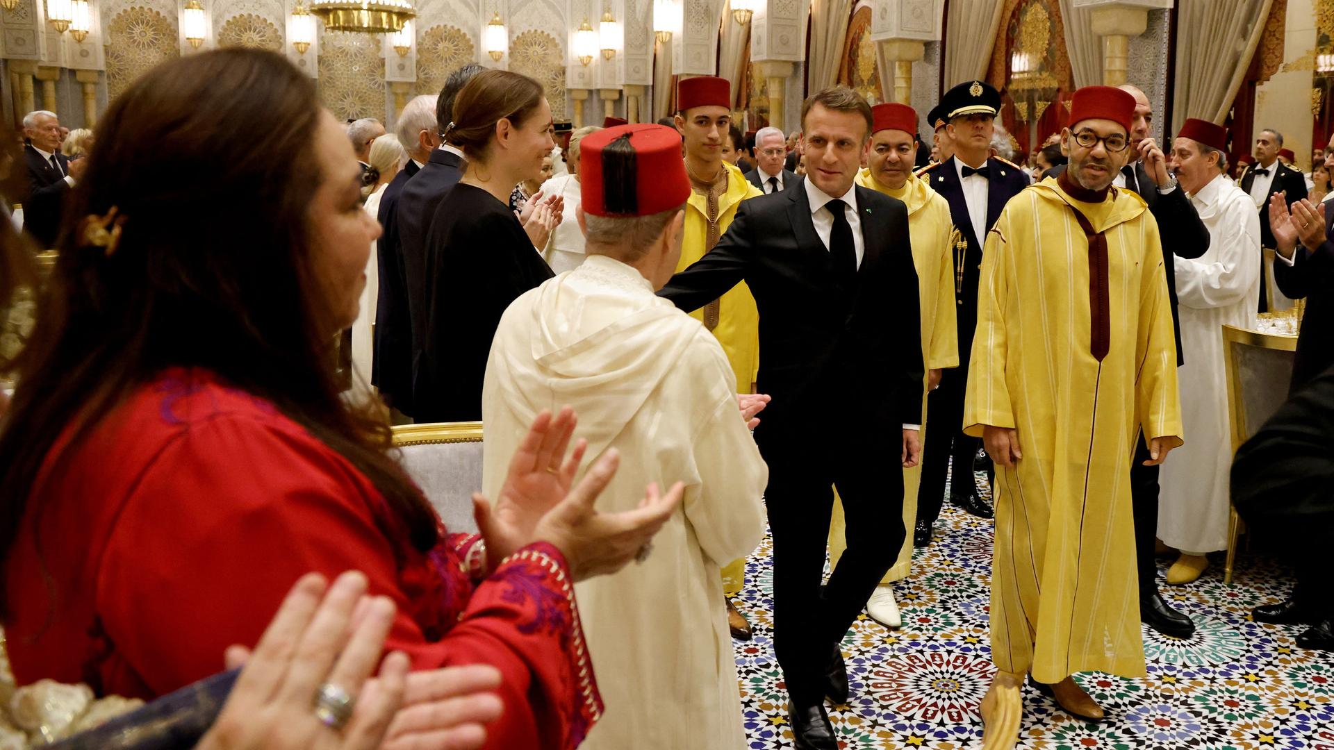 Frankreichs Präsident Emmanuel Macron und Marokkos König Mohammed VI gehen gemeinsam durch die Reihen einer Dinner-Gesellschaft im königlichen Palast in Rabat. Frankreichs Präsident Emmanuel Macron und Marokkos König Mohammed VI gehen gemeinsam durch die Reihen einer Dinner-Gesellschaft im königlichen Palast in Rabat.