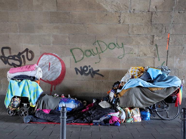 Die Habseligkeiten eines Obdachlosen stehen und liegen in einem Tunnel.