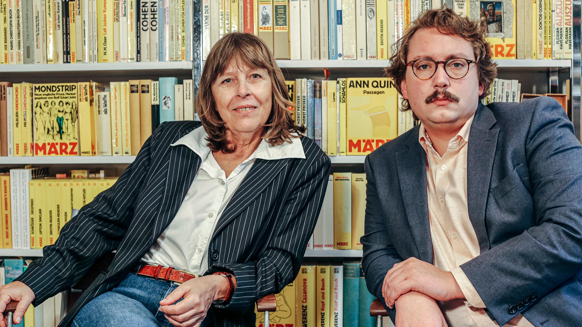 Barbara Kalender und Richard Stoiber, Verleger des März Verlags, sitzen vor einer Bücherwand. 