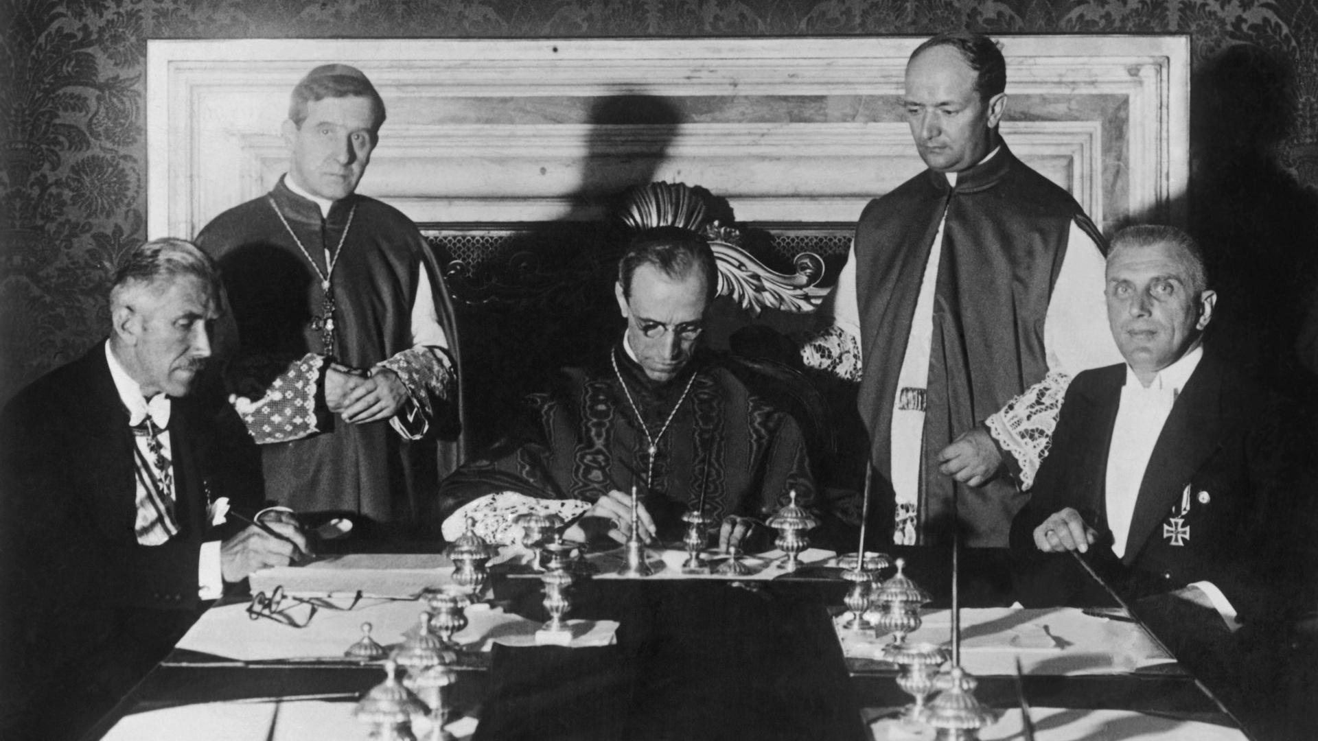 Bei der Unterzeichnung des Reichskonkordat zwischen dem Deutschen Reich und dem Heiligen Stuhl am 20. Juli 1933 im Vatikan sitzen (v.l.n.r) Vizekanzler Franz von Papen, Kardinalstaatssekretär Eugenio Pacelli und Ministerialdirektor Rudolf Buttmann an einem Tisch.