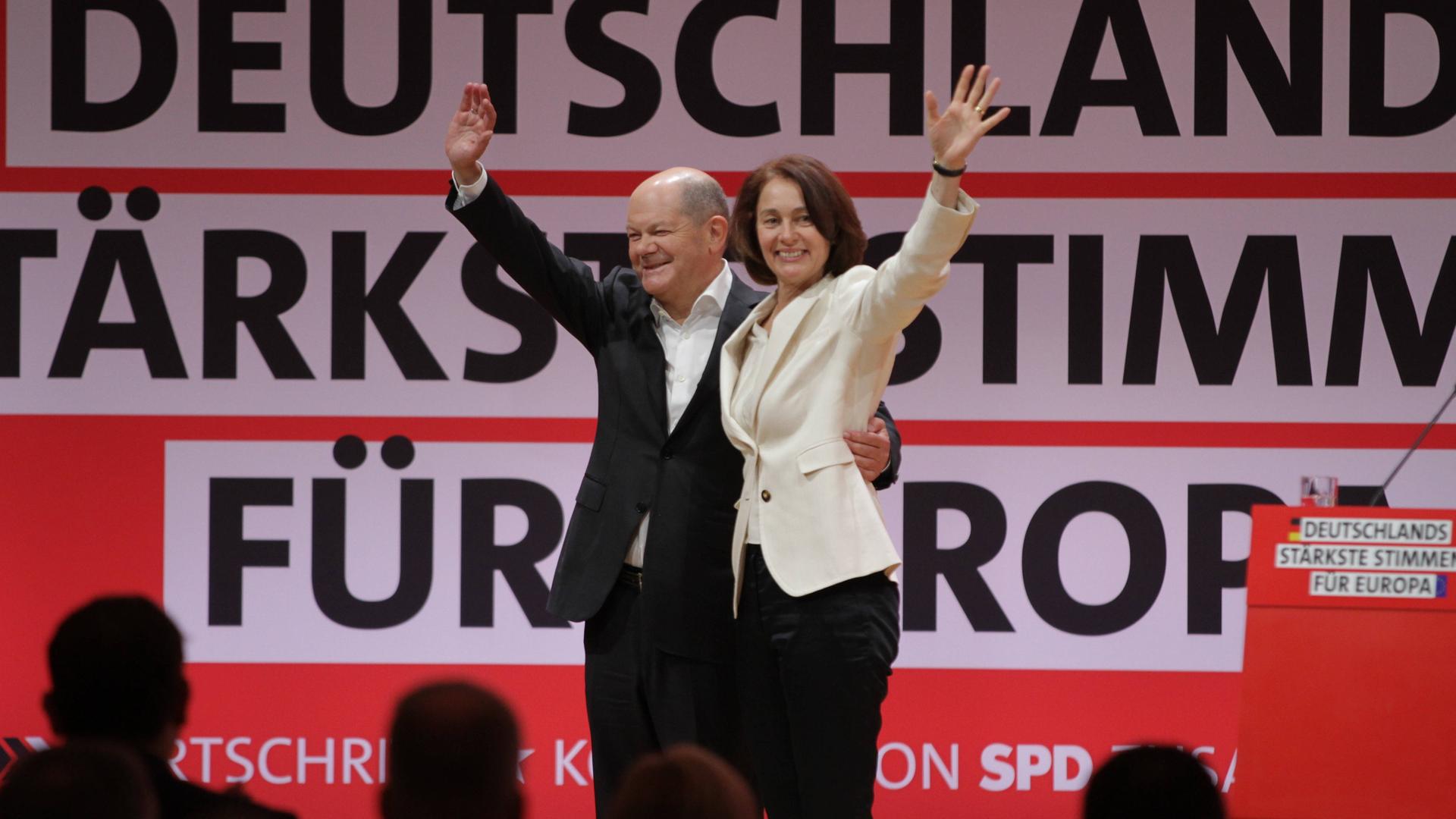 Kanzler Scholz und die SPD-Spitzenkandidatin für die Europawahl Barley lächeln und winken in die Menge.