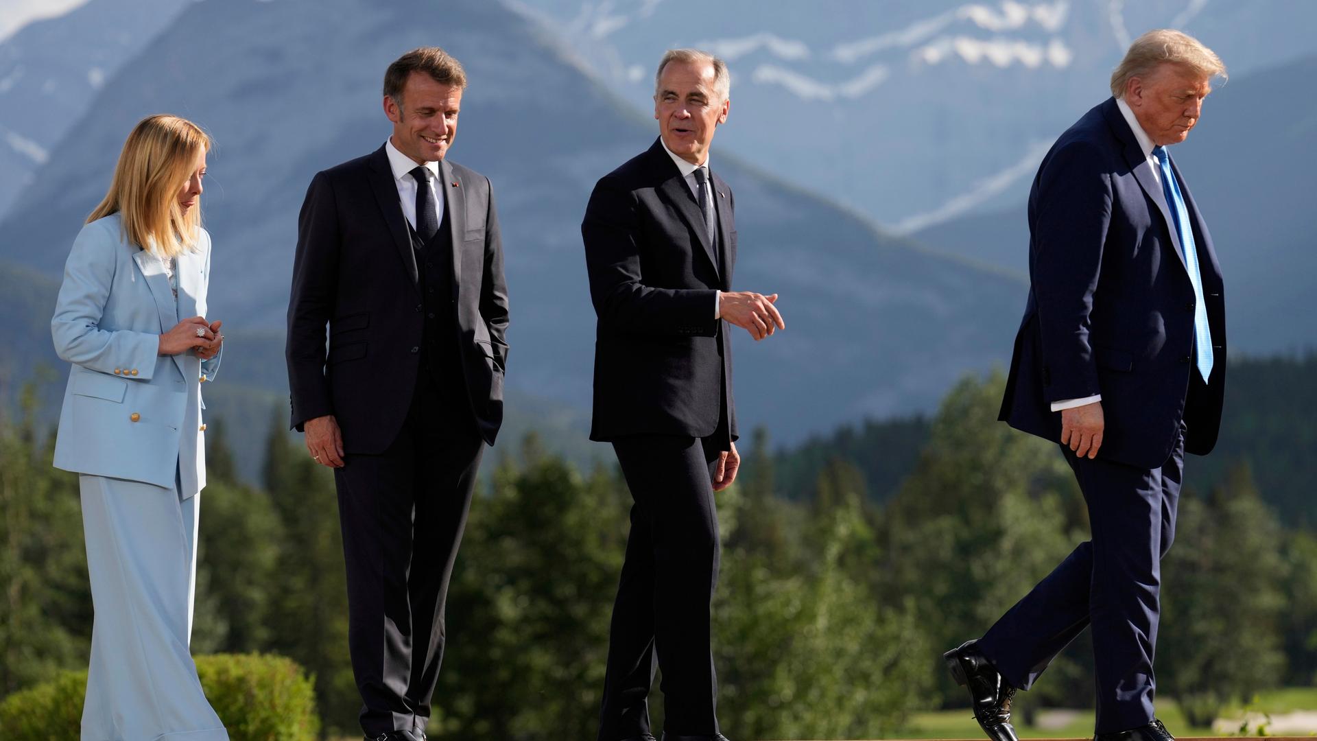 Georgia Meloni, Emmanuel Macron und Mark Carney verlassen hinter Donald Trump eine Bühne in den kanadischen Rocky Mountains