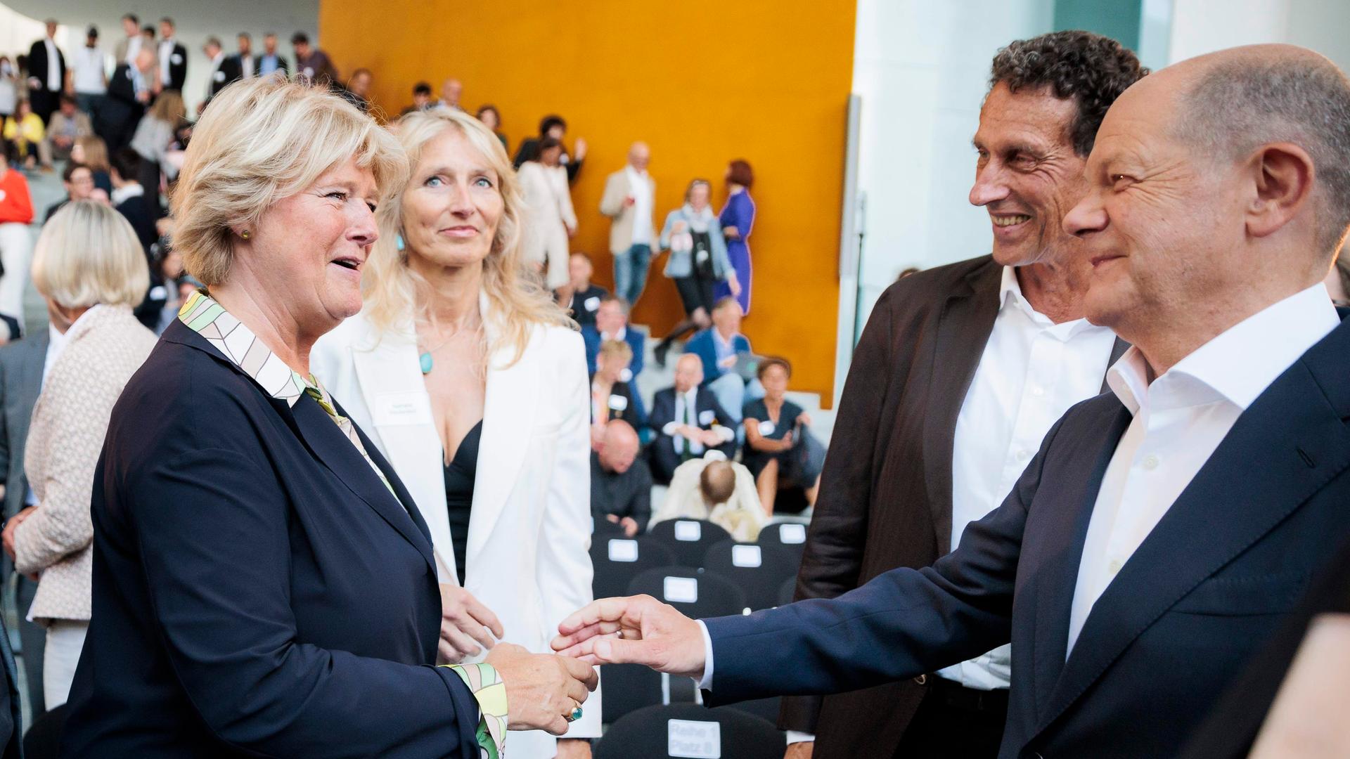 Bundeskanzler Olaf Scholz (r, SPD), begrüßt die ehemalige Beauftragte für Kultur und Medien (BKM), Monika Grütters (l. CDU), neben dem früheren Kulturstaatsminiter Julian Nida-Rümelin, bei dem Festakt zu 25+1 Jahre Bundeskulturpolitik im Bundeskanzleramt.