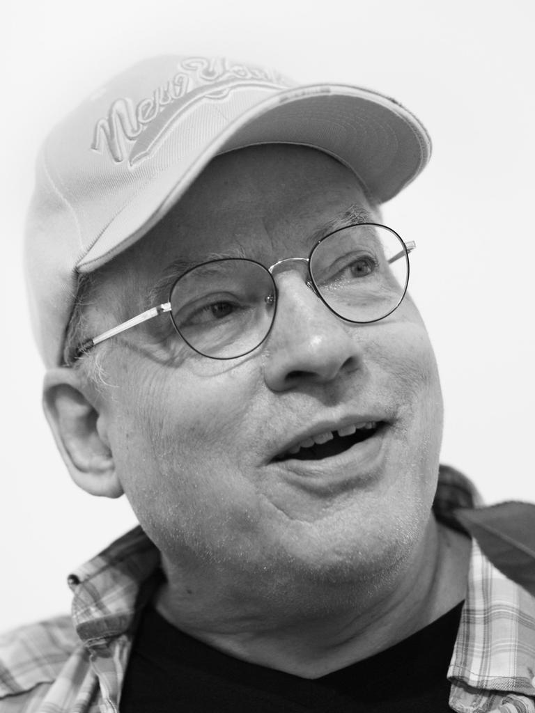 Der Filmemacher, Autor, Künstler und Schwulenaktivist Rosa von Praunheim hält eine Rose in der Hand.