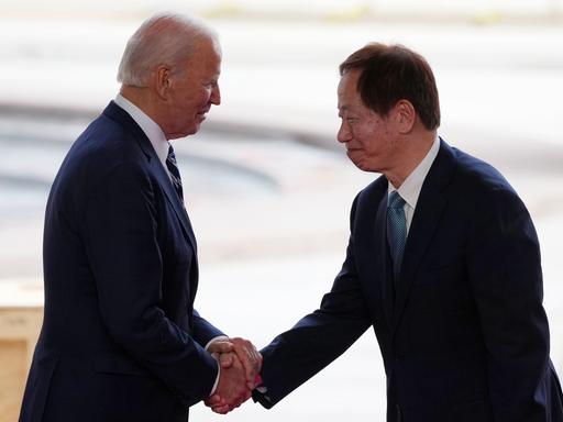 US-Präsident Joe Biden (l.) und Mark Liu, CEO von TSMC, geben sich auf einer Bühne die Hand.