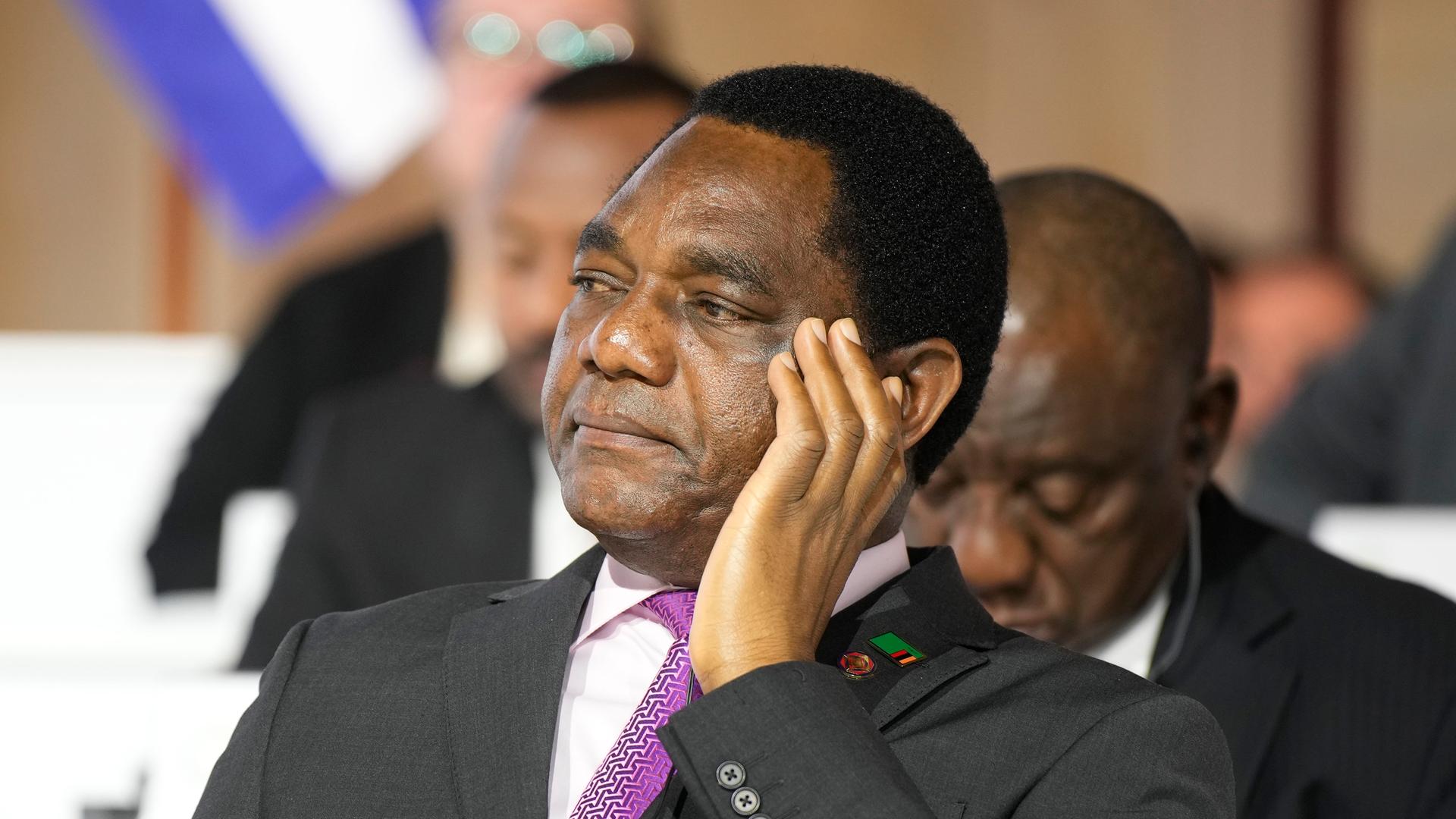 Der sambische Präsident Hakainde Hichilema hört in einer Konferenz zu. 