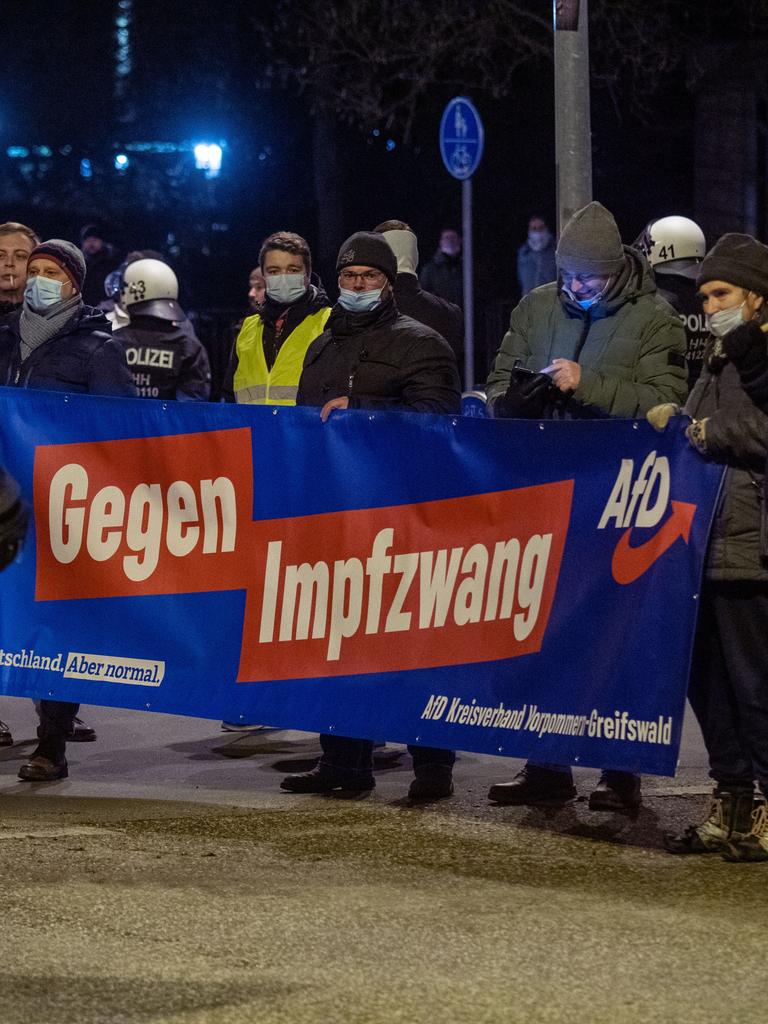 Mitglieder und Sympathisanten der Partei Alternative für Deutschland (AfD) demonstrieren in Greifswald gegen die Corona-Maßnahmen und tragen dabei ein Transparent mit der Aufschrift "Gegen Impfzwang AfD".