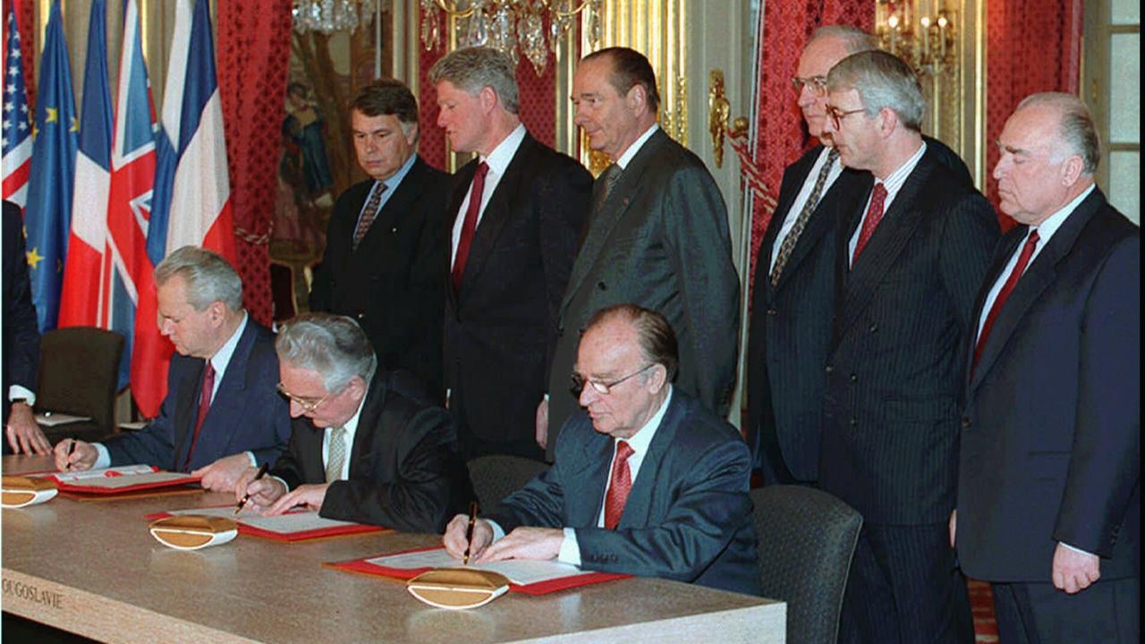 Unterzeichnung des Dayton-Abkommens 1995 durch führende Politiker von Serbien, Kroatien und Bosnien im Beisein mehrerer westlicher Staats- und Regierungschefs, unter ihnen US-Präsident Clinton und Bundeskanzler Kohl.