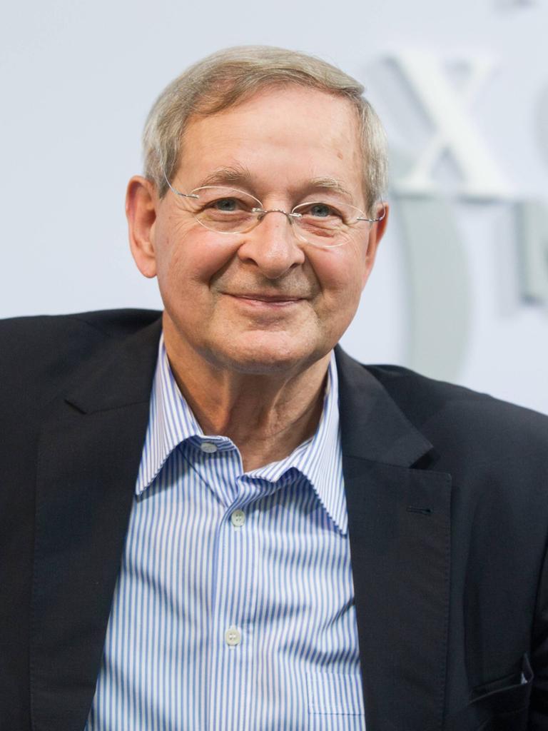 Der ungarische Schriftsteller Péter Nádas sitzt auf einem blauen Sofa Der ungarische Schriftsteller Péter Nádas sitzt auf einem blauen Sofa