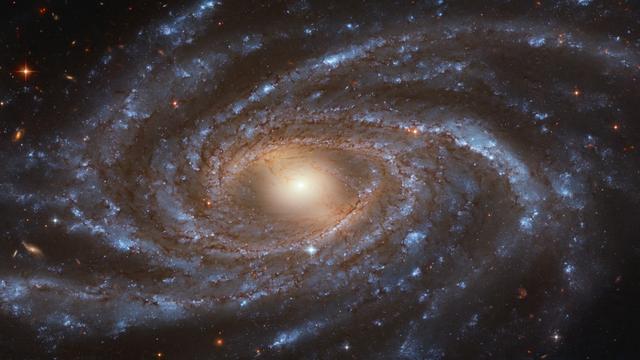 Im Kosmos gibt es offenbar viel Dunkle Materie und Dunkle Energie, die die Bewegung der Galaxien (hier NGC 2336) beeinflussen.