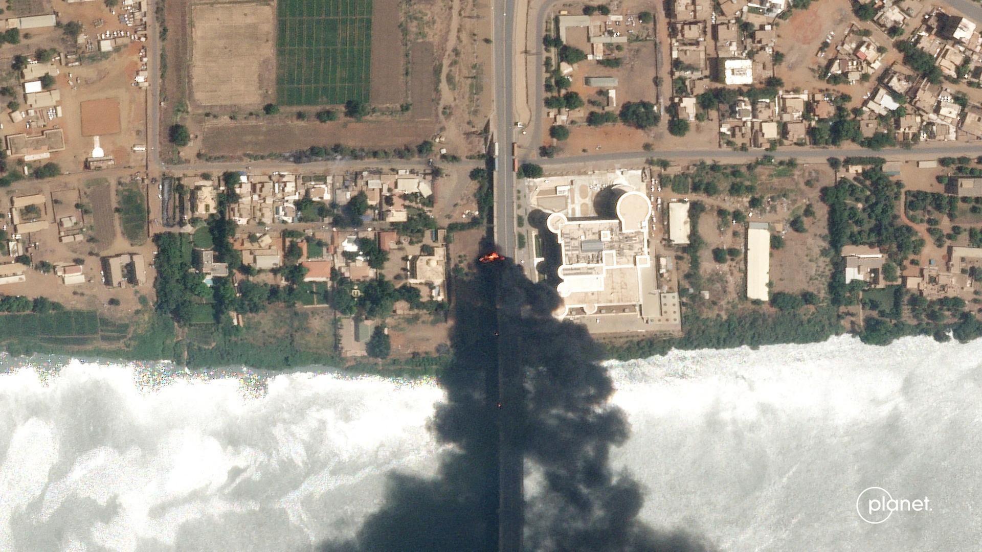 Ein Satellitenfoto zeigt Brände in der Nähe eines Krankenhauses in Khartum im Sudan. Schwarzer Rauch steigt über einem Gebäude empor. Ein Satellitenfoto zeigt Brände in der Nähe eines Krankenhauses in Khartum im Sudan. Schwarzer Rauch steigt über einem Gebäude empor.