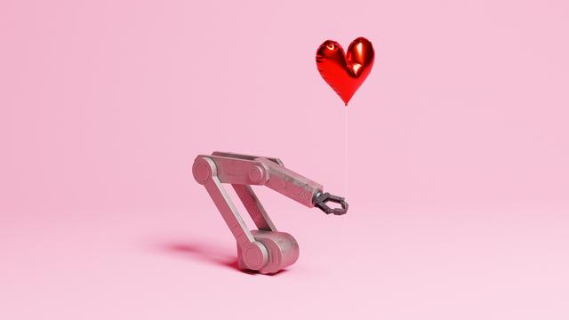 Eine Roboterarm, der einen herzförmigen Heliumballon auf einem rosa Hintergrund hält.