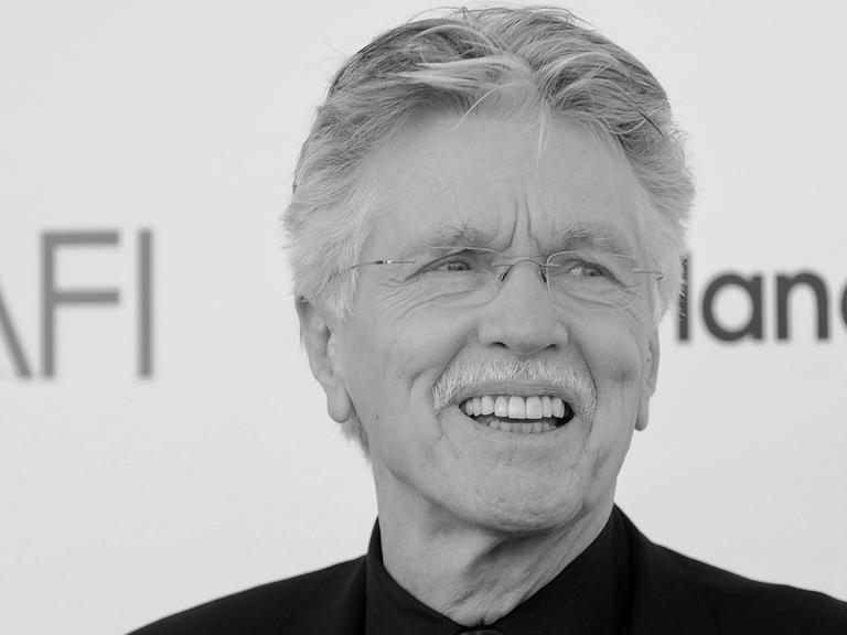 Tom Skerritt lächelt in einer Porträtaufnahme. Es ist ein schwarz-weiß-Foto des Schauspielers.